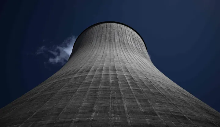 This photograph shows a cooling tower of the Civaux nuclear power plant, south-western France, on June 24, 2026. The plant operates two 178-metre cooling towers ? the tallest in the French nuclear fleet ? to dissipate heat from its two pressurised water reactors on the Vienne river. (Photo by Philippe LOPEZ/AFP)