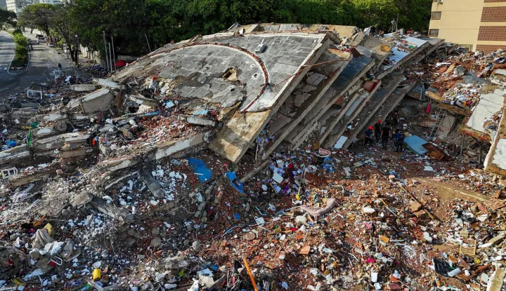Aerial view of collapsed buildings in Caraballeda, La Guaira state, Venezuela, on June 30, 2026, following earthquakes. Tens of thousands of people urgently need food and shelter in Venezuela due to the devastation from two huge earthquakes that killed more than 1,700 and injured 5,000, the UN said on June 30, 2026, as doctors warned of potential outbreaks of disease. (Photo by Miguel MEDINA/AFP)
