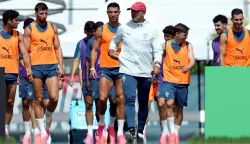 PALM BEACH GARDENS, FLORIDA - JUNE 30: Cristiano Ronaldo #7 and Head Coach Roberto Martinez of Portugal walk in the field during the training session ahead of the FIFA World Cup 2026 Round of 32 match between Portugal and Croatia at Gardens North County District Park on June 30, 2026 in Palm Beach Gardens, United States. Leonardo Fernandez/Getty Images/AFP (Photo by Leonardo Fernandez/GETTY IMAGES NORTH AMERICA/Getty Images via AFP)