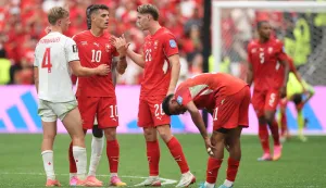 VANCOUVER, BRITISH COLUMBIA - JUNE 24: Granit Xhaka #10 of Switzerland and Luc de Fougerolles #4 of Canada embrace after the FIFA World Cup 2026 Group B match between Switzerland and Canada at BC Place Vancouver on June 24, 2026 in Vancouver, British Columbia. Alex Grimm/Getty Images/AFP (Photo by ALEX GRIMM/GETTY IMAGES NORTH AMERICA/Getty Images via AFP)