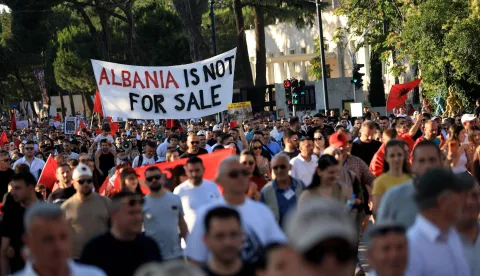 Protestors hold banners as they gather in front of the Albanian Prime Minister's Office to demonstrate against the construction on the southern coast of Albania a luxury resort near a protected natural area, in Tirana, on June 10, 2026. Several thousand citizens have demonstrated in Tirana for more than a week to demand transparency around a tourist complex project allegedly linked to US President's son-in-law, Jared Kushner. The demonstrators argue that the estimated .2 billion project, led by Kushner and his wife Ivanka, will harm the environment, with plans for luxury hotels in the protected area of Vjosa-Narta on the southern coast. (Photo by Adnan Beci/AFP)