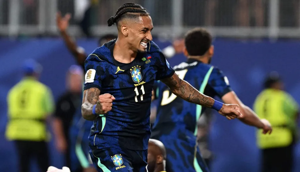 Brazil's forward #11 Raphinha celebrates his team's first goal scored by forward #09 Matheus Cunha (in the background) during the 2026 World Cup Group C football match between Brazil and Haiti at the Philadelphia Stadium in Philadelphia on June 19, 2026. (Photo by ROBERTO SCHMIDT/AFP)