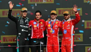(L-R) Mercedes' British driver George Russell, Ferrari race engineer, Bryan Bozzi, Ferrari's Monegasque driver Charles Leclerc and Ferrari's British driver Lewis Hamilton pose on the podium after Leclerc wins the Formula One British Grand Prix at the Silverstone motor racing circuit in Silverstone, central England, on July 5, 2026. (Photo by Andrej ISAKOVIC/AFP)