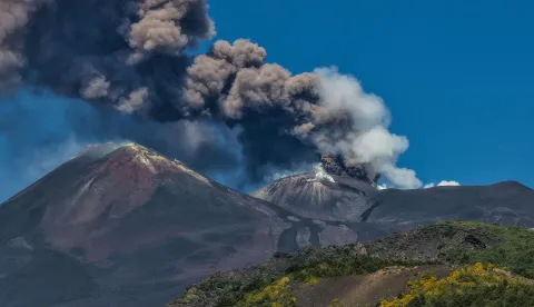 A photograph taken on July 5, 2026 shows smoke rising from the crater during an eruption of the Mount Etna volcano in Sicily. (Photo by Etna Walk/AFP)