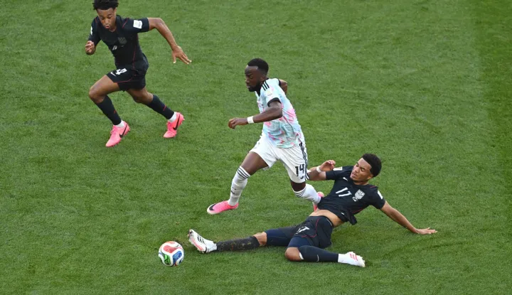 SEATTLE, WASHINGTON - JULY 06: Dodi Lukebakio #14 of Belgium is tackled by Malik Tillman #17 of the United States during the FIFA World Cup 2026 Round of 16 match between USA and Belgium at Seattle Stadium on July 06, 2026 in Seattle, Washington. David Ramos/Getty Images/AFP (Photo by David Ramos/GETTY IMAGES NORTH AMERICA/Getty Images via AFP)