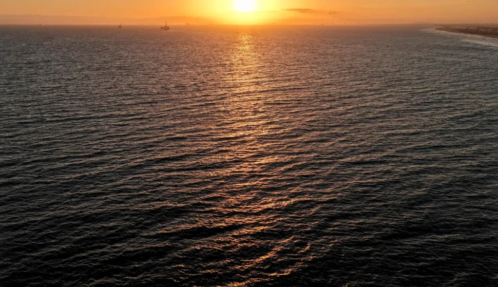 HUNTINGTON BEACH, CALIFORNIA - JULY 01: In an aerial view, the sun sets over the Pacific Ocean on July 01, 2026 in Huntington Beach, California. Global ocean sea surface temperatures broke records in June, according to the EU?s Copernicus Climate Change Service and the Copernicus Marine Service. Earth?s average ocean temperatures hit about 21 degrees Celsius (around 69.5 degrees Fahrenheit) on June 21, marking an ?unprecedented? new record for June amid the onset of ?El Ni?o?. Mario Tama/Getty Images/AFP (Photo by MARIO TAMA/GETTY IMAGES NORTH AMERICA/Getty Images via AFP)