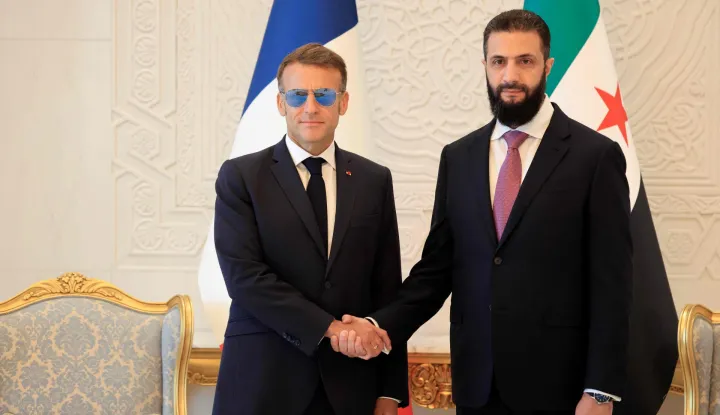 France's President Emmanuel Macron (L) shakes hands with Syrian President Ahmed al-Sharaa ahead of their meeting at the People's Palace in Damascus on July 7, 2026. French President Emmanuel Macron arrived in Damascus on July 6, 2026 for the first visit by a Western European head of state since Syria's new authorities took power in 2024, an AFP journalist said. Macron, who will depart on July 7, 2026, will advocate for "a free, pluralist Syria that respects each of its components" and plays a role in moderating Middle East tensions, the French presidency told journalists ahead of his arrival. (Photo by Ludovic MARIN/POOL/AFP)
