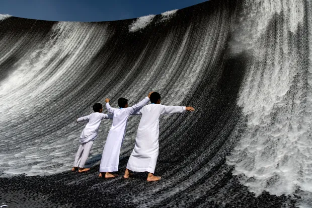 epa11017297 Boys enjoy the Surreal Water Feature in Green Zone at Expo City Dubai, the venue of the 2023 United Nations Climate Change Conference (COP28), in Dubai, United Arab Emirates, 08 December 2023. The 2023 United Nations Climate Change Conference (COP28), runs from 30 November to 12 December, and is expected to host one of the largest number of participants in the annual global climate conference as over 70,000 estimated attendees, including the member states of the UN Framework Convention on Climate Change (UNFCCC), business leaders, young people, climate scientists, Indigenous Peoples and other relevant stakeholders will attend. EPA/MARTIN DIVISEK