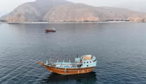 This aerial photograph shows boats anchored off Oman?s northern Musandam Peninsula near the Strait of Hormuz on June 27, 2026. Iran launched attacks on US sites in the Gulf in response to American strikes on the country, state media said on June 27, after Washington accused Tehran of attacking one of its cargo ships in the Strait of Hormuz. The trading of fire raised questions about efforts to keep the crucial waterway open while Washington and Tehran negotiate a final settlement to a war that began on February 28 with US and Israeli strikes on Iran. (Photo by AFP)/