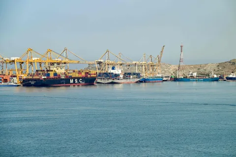 (L to R) The Liberia-flagged container vessel MSC Tasman VI, the Singapore-flagged container vessel Wan Hai 353, and other ships are docked along a pier at the Khor Fakkan Container Terminal, the only natural deep-sea port in the region and one of the major container ports in Sharjah Emirate, along the Gulf of Oman on June 19, 2026. Mediators in the US-Iran conflict, including Pakistan, Saudi Arabia and Turkey, are due to gather for talks in Egypt on June 21. A deal signed earlier in the week by US President Donald Trump and his Iranian counterpart Masoud Pezeshkian, aims to end the conflict that began on February 28 with US-Israeli strikes on Iran. It also provides for the reopening of the Strait of Hormuz and the launch of a 60-day negotiation period on broader issues, including Tehran's nuclear programme. (Photo by AFP)/