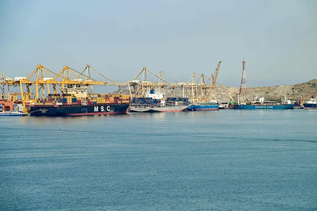 (L to R) The Liberia-flagged container vessel MSC Tasman VI, the Singapore-flagged container vessel Wan Hai 353, and other ships are docked along a pier at the Khor Fakkan Container Terminal, the only natural deep-sea port in the region and one of the major container ports in Sharjah Emirate, along the Gulf of Oman on June 19, 2026. Mediators in the US-Iran conflict, including Pakistan, Saudi Arabia and Turkey, are due to gather for talks in Egypt on June 21. A deal signed earlier in the week by US President Donald Trump and his Iranian counterpart Masoud Pezeshkian, aims to end the conflict that began on February 28 with US-Israeli strikes on Iran. It also provides for the reopening of the Strait of Hormuz and the launch of a 60-day negotiation period on broader issues, including Tehran's nuclear programme. (Photo by AFP)/