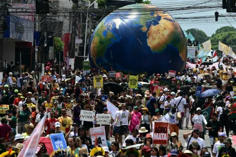 Thousands of people take part in the so-called "Great People's March" in the sidelines of the COP30 UN Climate Change Conference in Belem, Para State, Brazil on November 15, 2025. Thousands of people are expected to attend the march to demand "real solutions" to human-caused global warming, and which comes at the halfway point of contentious COP30 negotiations following two Indigenous-led protests that disrupted proceedings earlier in the week. (Photo by Pablo PORCIUNCULA/AFP)