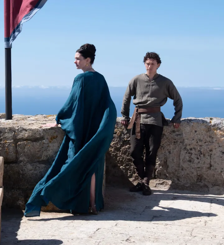 L to R: Anne Hathaway is Penelope and Tom Holland is Telemachus in THE ODYSSEY, written, produced, and directed by Christopher Nolan. (2026) 
