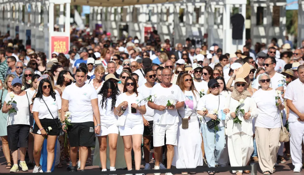 Relatives of victims killed in an attack in Nice on July 14, 2016, attend a commemorative walk on the "Promenade des anglais" on the French riviera city of Nice on July 12, 2026. A solemn march, an interfaith ceremony, a military parade and a memorial service presided over by French President are on the programme for the commemorations marking the 10th anniversary of the attack on the Promenade des Anglais in Nice, as announced by the city council on July 1, 2026.On July 14, 2016, Mohamed Lahouaiej-Bouhlel, a Tunisian national, drove a 19-tonne lorry for nearly 2 km into the crowd that had just been watching the fireworks, killing 86 people and injuring more than 400 before he was shot dead. (Photo by Valery HACHE/AFP)