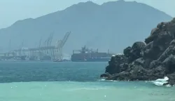 This frame grab taken from AFPTV video footage on July 12, 2026 shows a ship sailing near the Strait of Hormuz off the eastern coast of the United Arab Emirates at Khor Fakkan. Tehran announced it was closing the Strait of Hormuz on July 12 and launched missiles and drones at its Gulf neighbours, in retaliation for new US strikes following an attack by Iranian forces on a merchant vessel that was abandoned in flames by its crew. (Photo by AFPTV/AFP)/Attention editors: AFP covers the war in the Middle East through its extensive regional network, including bureaus in Tehran, Jerusalem and several neighboring countries.Since the start of the conflict, journalists have been working under increasingly restrictive conditions. Authorities in several countries have limited reporters? movements, photo and live video coverage from sensitive locations. Some governments and armed groups have banned images of missile or drone strikes and other security-related sites./