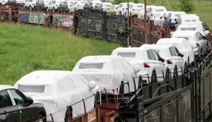 (FILES) Cars of the Volkswagen (VW) group are transported by rail on the compound at production site of the German carmaker in Emden, northern Germany, on May 20, 2022. Europe's largest carmaker Volkswagen is considering cutting tens of thousands more jobs worldwide and shuttering up to four plants in Germany, Manager Magazin reported on June 2026. Volkswagen is already planning to cut 50,000 jobs across its brands in Germany by 2030 as it is struggling with high costs, US tariffs and fierce Chinese competition in electric vehicles. Volkswagen would also close plants at Hanover, Zwickau and Emden after production runs of models currently made there end. (Photo by DAVID HECKER/AFP)