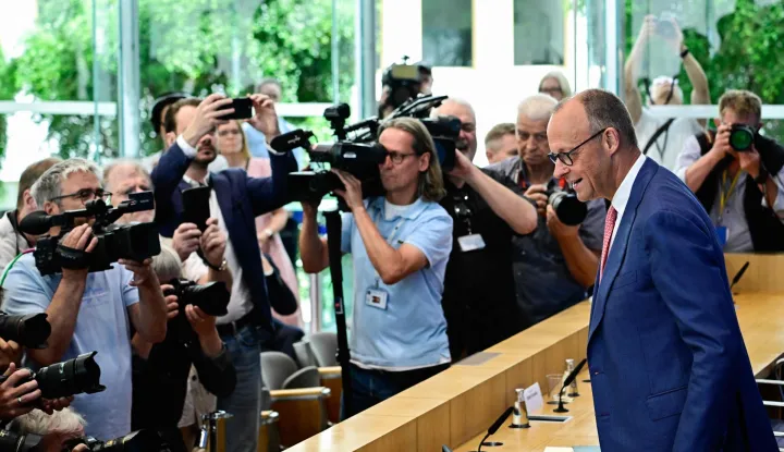 German Chancellor Friedrich Merz faces cameramen and photographers as he arrives to address journalists during his summer press conference in Berlin, Germany, on July 15, 2026. (Photo by Tobias SCHWARZ/AFP)