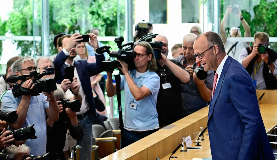 German Chancellor Friedrich Merz faces cameramen and photographers as he arrives to address journalists during his summer press conference in Berlin, Germany, on July 15, 2026. (Photo by Tobias SCHWARZ/AFP)