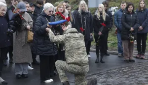 epa12564562 The mother of late Ukrainian serviceman Yukhym Agafontsev, 22, is presented with the folded national flag during his funeral at Baykove cemetery in Kyiv, Ukraine, 02 December 2025, amid the ongoing Russian invasion. Agafontsev, who used the callsign 'Snizhok' (Snowball), was a soldier with the 3rd Separate Assault Brigade of the Ukrainian Ground Forces and was killed in action in the Luhansk region on 04 August 2025. Russian troops entered Ukrainian territory on 24 February 2022, starting a conflict that has resulted in massive destruction and an ongoing humanitarian crisis. EPA/SERGEY DOLZHENKO