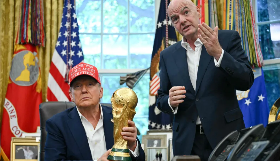 (FILES) US President Donald Trump joined by FIFA president Gianni Infantino (R) holds the World Cup Trophy as he makes an announcement in the Oval Office of the White House in Washington, DC, on August 22, 2025. US President Donald Trump will attend the World Cup final in New Jersey on July 19 and present the trophy to the winners, FIFA President Gianni Infantino announced on June 23, 2026. "We will be together with the president enjoying the final and handing the trophy to the winner, of course, together," Infantino told Fox and Friends. (Photo by ANDREW CABALLERO-REYNOLDS/AFP)