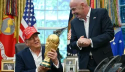 (FILES) US President Donald Trump joined by FIFA president Gianni Infantino (R) holds the World Cup Trophy as he makes an announcement in the Oval Office of the White House in Washington, DC, on August 22, 2025. US President Donald Trump will attend the World Cup final in New Jersey on July 19 and present the trophy to the winners, FIFA President Gianni Infantino announced on June 23, 2026. "We will be together with the president enjoying the final and handing the trophy to the winner, of course, together," Infantino told Fox and Friends. (Photo by ANDREW CABALLERO-REYNOLDS/AFP)