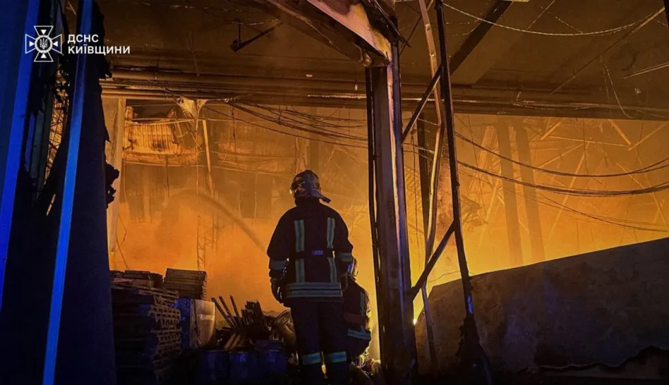 This handout photograph taken and released by the Ukrainian State Emergency Service on July 19, 2026 shows a rescuer putting out a fire in a logistics facility and warehouses following missile strikes on the Bucha district, near Ukrainian capital of Kyiv, amid the Russian invasion of Ukraine. Russian missiles rocked Ukraine's capital overnight, damaging residential buildings and wounding at least two people a day after Kyiv launched a wave of drone strikes deep into Russian territory. (Photo by Handout/Ukrainian State Emergency Service/AFP)