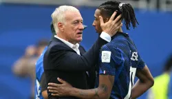 France's head coach Didier Deschamps and France's forward #11 Michael Olise hug after losing the 2026 World Cup football tournament third-place match between France and England at the Miami Stadium in Miami on July 18, 2026. (Photo by ROBERTO SCHMIDT/AFP)