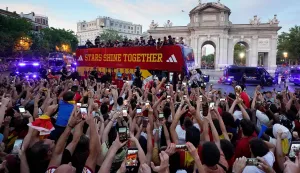Spain's players parade onboard an open-top bus through the streets of Madrid on July 20, 2026, one day after the national football team won their second World Cup title following a 1-0 victory against Argentina. Spain's World Cup winners come back home to a heroes' welcome in Madrid, where a million fans are expected to greet them after a night of raucous celebrations across the country. (Photo by Paul Hanna/AFP)