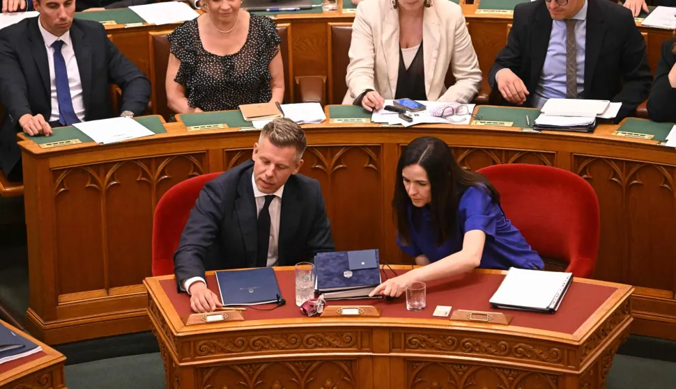 Lawmakers including Hungarian Prime Minister Peter Magyar (first row, L) and Foreign Minister Anita Orban (R) vote on a constitutional amendment at the extraordinary session of parliament at the House of Representatives in Budapest, Hungary on July 13, 2026. The Hungarian parliament on on July 13, 2026 passed a constitutional tweak to oust the country's president, whom new Prime Minister Peter Magyar accuses of being a "puppet" of hardline ex-leader Viktor Orban. Lawmakers from Magyar's Tisza party broke into a half-minute-long standing ovation after voting to eject unpopular President Tamas Sulyok from office by 139 votes to six, in a ballot boycotted by Orban's nationalist Fidesz party. (Photo by Attila KISBENEDEK/AFP)