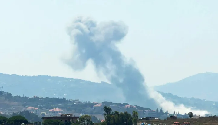 This photograph taken from the southern Lebanese city of Nabatieh shows smoke rising from the site of an Israeli controlled explosion in Kfar Tibnit village on July 21, 2026. The Lebanese army announced on July 21 that it had begun deploying to an area in the south, one of three "pilot zones" outlined in a deal with Israel to disarm Hezbollah. (Photo by Abbas Fakih/AFP)