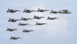 This US Navy handout photo released on July 15, 2026 and taken on June 30 by US Central Command Public Affairs shows fixed wing aircraft flying over Arleigh Burke-class guided-missile destroyer USS Frank E. Petersen Jr. (DDG 121) during a photo exercise. The US launched a wave of strikes against Iran on July 15, after it reimposed a naval blockade in a return to war between the two foes. Nearly a month after they signed a memorandum of understanding towards ending the Middle East war, the two sides resumed fighting with strikes on targets across the region. (Photo by US NAVY/AFP)/RESTRICTED TO EDITORIAL USE - MANDATORY CREDIT "AFP PHOTO/US NAVY/NAVCENT PUBLIC AFFAIRS" - HANDOUT - NO MARKETING NO ADVERTISING CAMPAIGNS - DISTRIBUTED AS A SERVICE TO CLIENTS