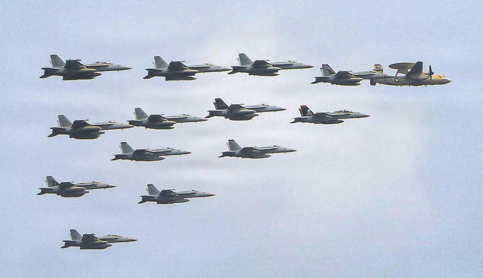This US Navy handout photo released on July 15, 2026 and taken on June 30 by US Central Command Public Affairs shows fixed wing aircraft flying over Arleigh Burke-class guided-missile destroyer USS Frank E. Petersen Jr. (DDG 121) during a photo exercise. The US launched a wave of strikes against Iran on July 15, after it reimposed a naval blockade in a return to war between the two foes. Nearly a month after they signed a memorandum of understanding towards ending the Middle East war, the two sides resumed fighting with strikes on targets across the region. (Photo by US NAVY/AFP)/RESTRICTED TO EDITORIAL USE - MANDATORY CREDIT "AFP PHOTO/US NAVY/NAVCENT PUBLIC AFFAIRS" - HANDOUT - NO MARKETING NO ADVERTISING CAMPAIGNS - DISTRIBUTED AS A SERVICE TO CLIENTS