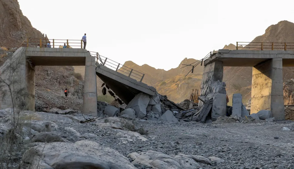 TOPSHOT - A heavily-damaged bridge which was hit by a US strike is pictured along the road connecting Roudan and Bandar Abbas in southern Iran on July 18, 2026. The United States hit Iran on July 17, with Tehran accusing US forces of striking civilians sites and drawing Iranian threats of reprisals on regional infrastructure. A battle over the strategic Strait of Hormuz has rekindled the war in the Middle East and the foes have traded fire for six days running. (Photo by Amir Hossein KHORGOOEI/ISNA/AFP)/