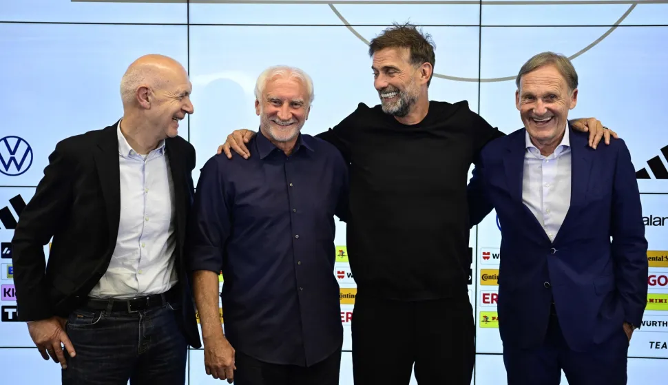 (From L) German Football Association (DFB) President Bernd Neuendorf, Director of Germany's national football team Rudi Voeller, Germany's newly appointed national football team head coach Juergen Klopp and the Vice-President of the German Football Ligue DFL Hans-Joachim Watzke pose at the end of a press conference at the headquarters of the German Football Federation (DFB) in Frankfurt am Main, western Germany on July 24, 2026. Jurgen Klopp is widely expected to formally take over as the new head coach of the German men's national football team, with the German Football Association (DFB) calling a press conference for July 24, 2026.Klopp, famed for his success during stints as coach at Borussia Dortmund and especially Liverpool, has been in talks with the DFB about trying to lead Germany -- long a football powerhouse -- back to prominence. (Photo by John MACDOUGALL/AFP)