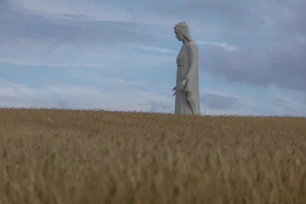A statue of the Virgin Mary is seen over the field in Konotopie village, next to Torun, central Poland on July 22, 2026. In a nondescript village in northern-central Poland, a statue of the Virgin Mary, towers above what residents hope is the traditionally Catholic country's newest pilgrimage destination. At 55 meters high, the concrete and steel beam figure in Konotopie is the tallest Marian statue in Europe, and second in the world. (Photo by Wojtek RADWANSKI/AFP)
