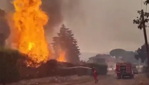 This screengrab from a video posted on the X account of Spain's Military Emergencies Unit UME (@UMEgob) on July 23, 2026, shows UME personnel fighting a wildfire in San Mart?n de Valdeiglesias, Madrid. In Spain, a fire broke out on July 22 afternoon in Almorox, near Toledo, southwest of Madrid, leading to the evacuation of several municipalities in the area and the lockdown of one of them, emergency services announced on X. Reflecting the rapid spread of the fire, authorities and emergency services twice sent an alert message to all mobile phones in the area to warn of the situation. (Photo by Handout/X account of Spain's Military Emergencies Unit UME (@UMEgob)/AFP)/RESTRICTED TO EDITORIAL USE - MANDATORY CREDIT "AFP PHOTO/X account of Spain's Military Emergencies Unit UME (@UMEgob)/HANDOUT" - NO MARKETING NO ADVERTISING CAMPAIGNS - DISTRIBUTED AS A SERVICE TO CLIENTS