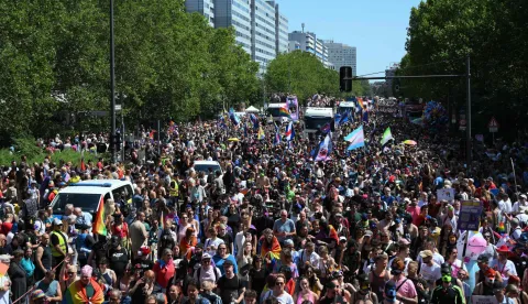 Participants march during the Christopher Street Day (CSD) parade along Leipziger Strasse in Berlin on July 25, 2026. This year's CSD parade takes place under the slogan 'Taking a stand is Hot', where various groups will demonstrate in support of diversity, human rights, and the protection of minorities. (Photo by RALF HIRSCHBERGER/AFP)