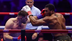 Britain's Anthony Joshua (R) and Albania's Kristian Prenga (L) trade blows during their heavyweight boxing fight at the Jeddah Superdome in Jeddah on July 26, 2026. Two-time heavyweight world champion Anthony Joshua survived two early knockdowns on the way to a second-round knockout of Kristian Prenga on July 26, his triumphant ring return paving the way for a blockbuster all-British bout with Tyson Fury. (Photo by AFP)