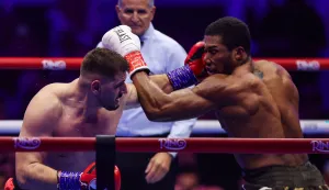 Britain's Anthony Joshua (R) and Albania's Kristian Prenga (L) trade blows during their heavyweight boxing fight at the Jeddah Superdome in Jeddah on July 26, 2026. Two-time heavyweight world champion Anthony Joshua survived two early knockdowns on the way to a second-round knockout of Kristian Prenga on July 26, his triumphant ring return paving the way for a blockbuster all-British bout with Tyson Fury. (Photo by AFP)