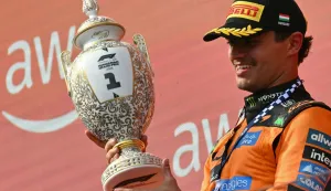 Winner McLaren's British driver Lando Norris celebrates with the trophy after the Formula One Hungarian Grand Prix at the Hungaroring racetrack in Mogyorod near Budapest, Hungary, on July 26, 2026. (Photo by Andrej ISAKOVIC/AFP)