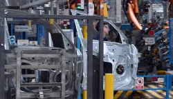 An employee works at the Ford factory in Almussafes, near Valencia on July 23, 2026. US automaker Ford announced today that it plans to create a joint venture with Chinese group Geely at its struggling Spanish plant in Valencia, which will produce four additional models for both companies. (Photo by JOSE JORDAN/AFP)