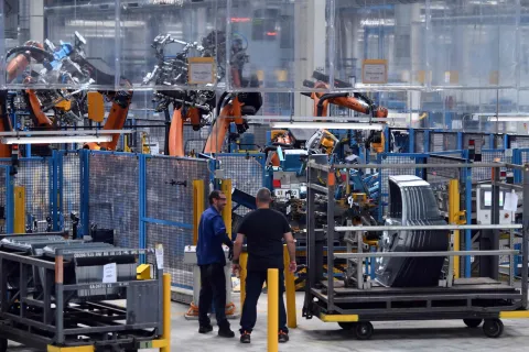 Employees work at the Ford factory in Almussafes, near Valencia on July 23, 2026. US automaker Ford announced today that it plans to create a joint venture with Chinese group Geely at its struggling Spanish plant in Valencia, which will produce four additional models for both companies. (Photo by JOSE JORDAN/AFP)