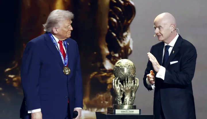 epa12572626 US President Donald Trump (L) receives the FIFA Peace Prize from FIFA President Giovanni Infantino during the FIFA World Cup 2026 Final Draw at the Kennedy Center in Washington DC, USA, 05 December 2025. EPA/WILL OLIVER