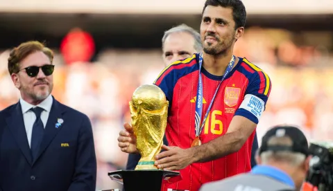 EAST RUTHERFORD, NEW JERSEY - JULY 19: Rodri #9 of Spain picks up the FIFA World Cup Winner?s Trophy after defeating Argentina in the FIFA World Cup 2026 Final at New York New Jersey Stadium on July 19, 2026 in East Rutherford, New Jersey. Spain defeated reigning World Cup champions Argentina, who were led by Lionel Messi, with the lone goal coming from Ferran Torres #7 in the 106th minute of extra time. Andrew Harnik/Getty Images/AFP (Photo by Andrew Harnik/GETTY IMAGES NORTH AMERICA/Getty Images via AFP)