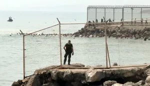 This video frame grab obtained from an AFP video shows migrants swimming in the sea to reach the shore of Spanish north African exclave of Ceuta, in Ceuta on July 30, 2026. Hundreds of migrants entered the Spanish north African exclave of Ceuta today, AFP reporters saw, many of them having swum by sea around the frontier fence. Migration from Morocco into Spain's two north African territories, Ceuta and Melilla, has long been a politically sensitive issue between the two countries, as thousands cross the border at times. AFP reporters saw a stream of adults and children, most of them wet, entering the town. (Photo by Luc?a DIAZ/AFP)