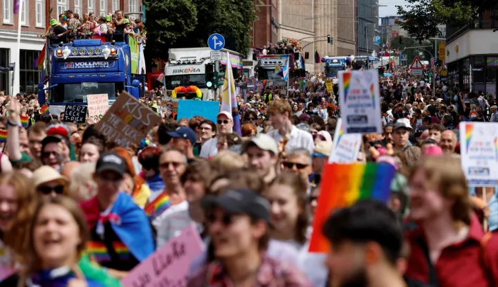 People are seen marching along or celebrating on trucks or floats during the Christopher Street Day (CSD) demonstration against discrimination of sexual minorities as part of the Hamburg Pride 2026 in the city centre of Hamburg, northern Germany on August 1, 2026. Organisers of the CSD demonstration, which takes place under the motto 'Queer solidarity. Taking a stand ? for a future without fear!', call for greater solidarity within the queer community and across society as a whole. (Photo by Focke Strangmann/AFP)