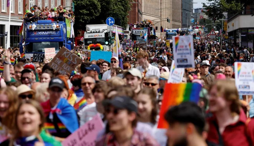 People are seen marching along or celebrating on trucks or floats during the Christopher Street Day (CSD) demonstration against discrimination of sexual minorities as part of the Hamburg Pride 2026 in the city centre of Hamburg, northern Germany on August 1, 2026. Organisers of the CSD demonstration, which takes place under the motto 'Queer solidarity. Taking a stand ? for a future without fear!', call for greater solidarity within the queer community and across society as a whole. (Photo by Focke Strangmann/AFP)