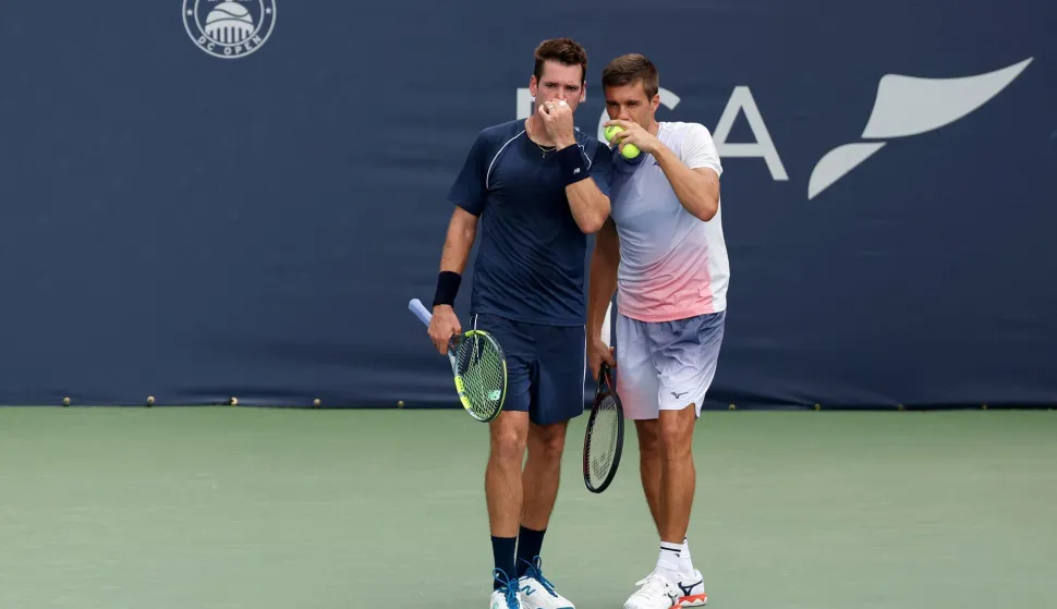 WASHINGTON, DC - AUGUST 02: Austin Krajicek of the United States and Nikola Mektic of Croatia talk during a men's doubles championship match against Julian Cash and Lloyd Glasspool of Great Britain on the final day of the Mubadala DC Open 2026 at William H.G. FitzGerald Tennis Center on August 02, 2026 in Washington, DC. Emilee Chinn/Getty Images/AFP (Photo by Emilee Chinn/GETTY IMAGES NORTH AMERICA/Getty Images via AFP)