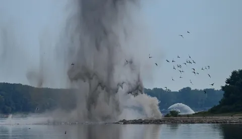 A controlled underwater explosion is pictured on the riverbed of the Danube River in Izvoarele village, on August 3, 2026. The blast aimed at deepening the channel and diverting a higher volume of water toward the cooling systems of the Cernavoda Nuclear Power Plant. Local authorities and plant engineers authorized the blasting operations to counteract critically low water levels caused by a prolonged summer heatwave, ensuring the continuous and safe operation of the facility's reactors. (Photo by Daniel MIHAILESCU/AFP)