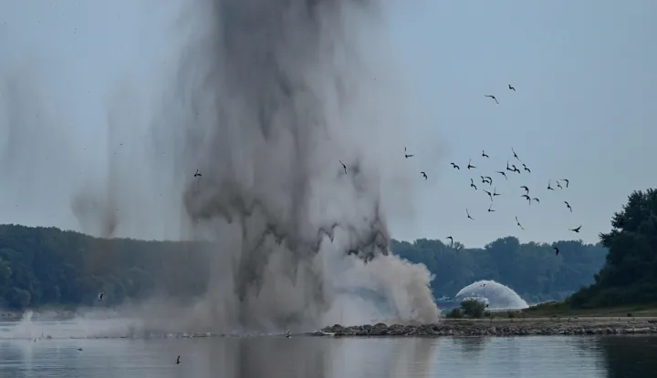 A controlled underwater explosion is pictured on the riverbed of the Danube River in Izvoarele village, on August 3, 2026. The blast aimed at deepening the channel and diverting a higher volume of water toward the cooling systems of the Cernavoda Nuclear Power Plant. Local authorities and plant engineers authorized the blasting operations to counteract critically low water levels caused by a prolonged summer heatwave, ensuring the continuous and safe operation of the facility's reactors. (Photo by Daniel MIHAILESCU/AFP)